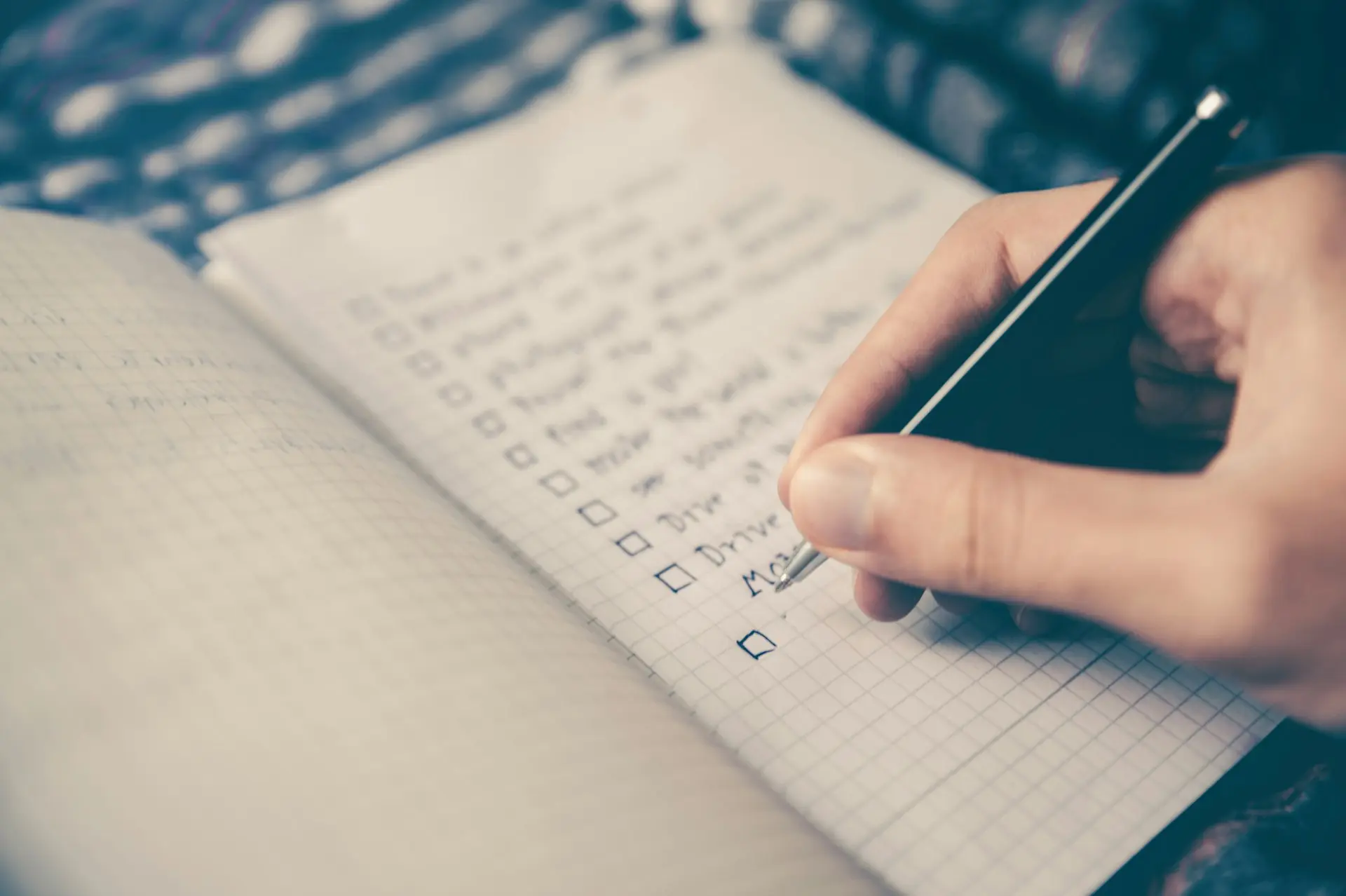 Teen tracking his progress and goals in a notebook