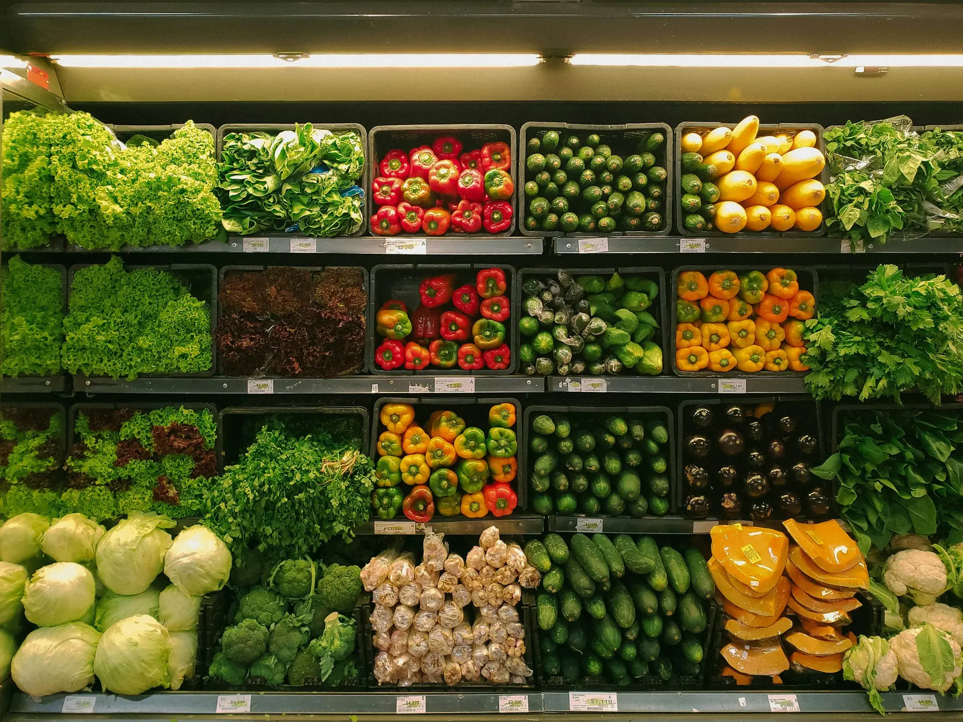 Shoppers in U.S. supermarket comparing prices as inflation eases